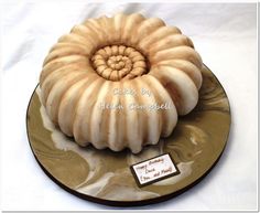 there is a cake that looks like a spirally shell on top of a plate