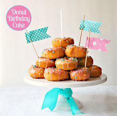 a cake with donuts on top and flags sticking out of it's sides