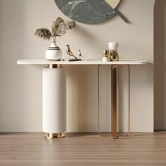 a white table with two vases sitting on top of it next to a clock