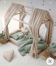 a child's bedroom with a canopy bed and green comforter on the floor