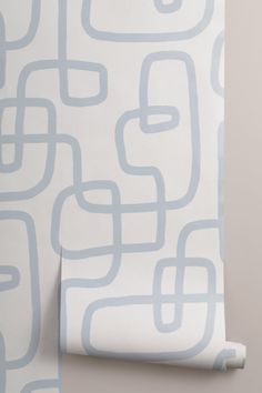 a white and blue wallpaper with an abstract design on it's back side