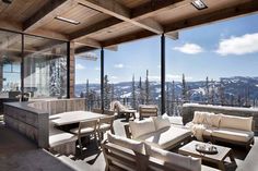 a living room filled with lots of furniture next to a kitchen and an outdoor dining area