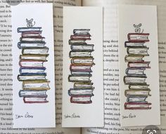 an open book with three different colored books sitting on top of each other and one has a drawing of a stack of books