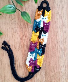 the beaded bookmark is decorated with cats