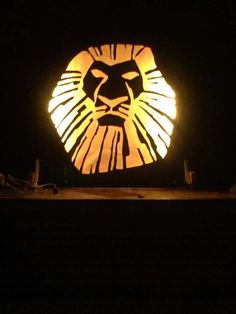 a lighted lion head in the dark