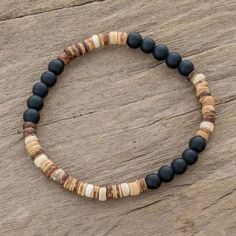 Onyx and Coconut Shell Beaded Stretch Bracelet - Earthen Force | NOVICA Handmade Black Holistic Bracelets, Holistic Black Handmade Bracelets, Holistic Handmade Black Bracelets, Handmade Black Beaded Bracelets, Handmade Holistic Black Beaded Bracelets, Spiritual Black Beaded Bracelets For Beach, Black Heishi Beads Bohemian Bracelet, Black Wooden Beads Bracelets For Meditation, Bohemian Black Heishi Beads Bracelets