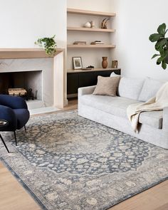 a living room filled with furniture and a fire place in the middle of the room