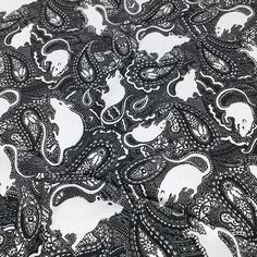 black and white paisley print fabric with an animal design on it's back side