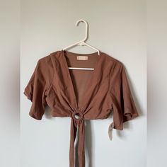 Super Cute Top For Going Out! It Ties In The Front/Around The Waist. Unworn And With Tags. The Brand Is Altard State. Fits Xs-M (It Fit Me And I Have 32dd Chest) Brown Short Sleeve Crop Top For Spring, Spring Brown Short Sleeve Crop Top, Brown Spring Beach Crop Top, Brown V-neck Crop Top For Spring, Brown V-neck Summer Top, Summer Brown V-neck Top, Brown Crop Top For Spring Vacation, Brown Crop Top For Vacation In Spring, Fitted Brown Crop Top For Spring