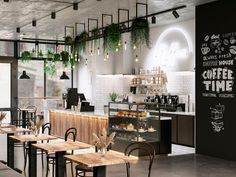 the interior of a coffee shop with tables, chairs and plants hanging from the ceiling