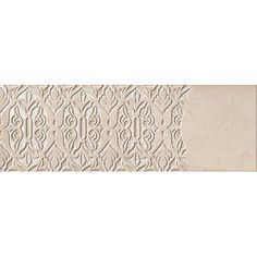 a white wall with an intricate design on the front and back panel, along with a beige background