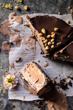 two pieces of chocolate cake with peanut butter on top and one slice cut out from it