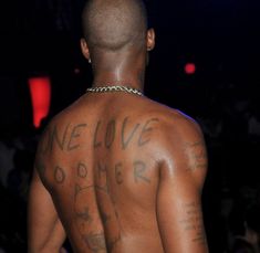 the back of a man with tattoos on his body