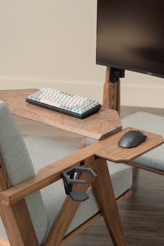 a computer desk with a keyboard, mouse and monitor sitting on it's side