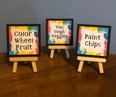 three small wooden eases with paintings on them that say color, goat, veggies and paint chips