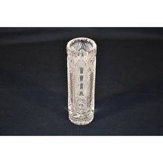 a clear glass vase sitting on top of a black table