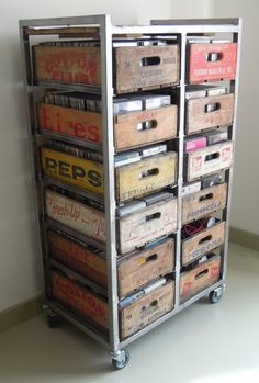 an old metal storage unit filled with lots of records and cassette's on wheels