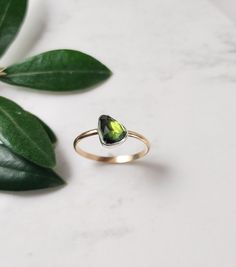 Stunning rose cut teardrop green Tourmaline gemstone set in a sterling silver bezel and finished with a 14k gold filled band. This beautiful ring makes a great gift for someone special or yourself. D E T A I L S . . . . . . . .  Metal: Sterling Silver & 14k Gold Filled Gemstone: Tourmaline  Size: 7 US Please feel free to contact us if you need another size. Handmade jewelry with Love and Passion by Grace Lilly Designs. Handcrafted in the USA. Green Teardrop Jewelry With Bezel Setting, Green Solitaire Teardrop Jewelry, Pear-shaped Tourmaline Gemstone Jewelry, Green Teardrop 14k Gold Ring, Tourmaline Solitaire Jewelry Gift, Tourmaline Solitaire Jewelry As Gift, Pear-shaped Tourmaline Jewelry As A Gift, Tourmaline Solitaire Jewelry For Gift, Pear-shaped Tourmaline Jewelry Gift