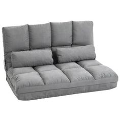 a gray couch with four pillows on it