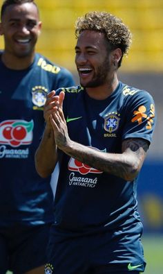 two soccer players are smiling and applauding each other