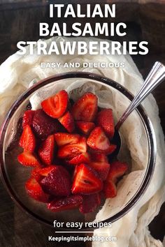 a bowl filled with sliced strawberries on top of a table