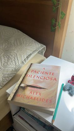 a stack of books sitting on top of a bed