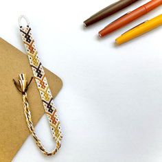 an envelope, pen, and markers on a table next to some crafting supplies