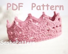 a pink crocheted crown sitting on top of a table