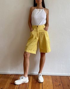 "Vintage 80s-90s minimal lightweight denim shorts. Features a zip fastening, a bermuda leg and  pocket detail. In a bright, yellow colour.  Brand: Il Tesoro Size label reads EU 36. 100% Cotton Based on measurements recommended size UK 8 - small 10 // EU 36 - small 38// US 4 - small 6 Model is UK size 6/8 and 5'4 and it has a relaxed fit. Pinned back at waist.  Length at front: 50cm Waist (circumference): 68cm // 26.5\" Hem (shorts leg measured flat): 30cm Hip (measured flat): 48cm // 19\" Hip (c Cotton Jean Knee-length Shorts For Summer, Knee-length Cotton Jean Shorts For Summer, Summer Cotton Jean Shorts Knee-length, Summer Cotton Knee-length Jean Shorts, Cotton Knee-length Jean Shorts For Summer, Retro Cotton Shorts For Spring, Retro Wide Leg Cotton Shorts, Retro Knee-length Shorts For Summer, Retro Cotton Jean Shorts For Summer