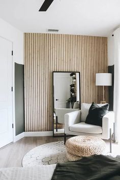 a living room with a white couch and mirror