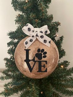 a christmas ornament with a dog's paw and the word love on it