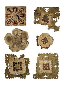 four pieces of art that are made out of wood and fabric with different designs on them