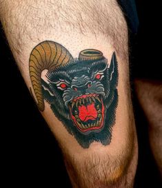 a man's leg with a demon tattoo on it