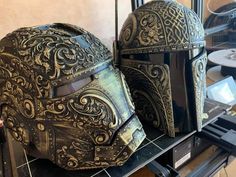 two helmets sitting on top of a table next to each other