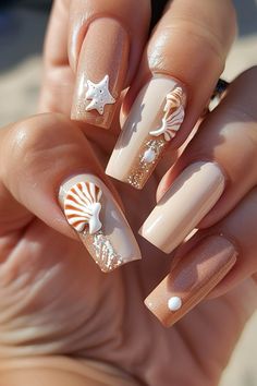 Beige manicured nails with marine-themed art and glitter accents against a sandy background. Trendy Vacation Nails, Perfect Summer Nails