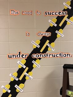 the road to success is always under construction bulletin board with yellow and black circles on it