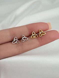 These sterling silver trinity Celtic knot earring studs are perfect for anyone looking to add a little sparkle to their everyday look. The minimalist design of the earrings makes them suitable to pair with any outfit, while the small size allows them to stay comfortably in place all day long. Not to mention, they are hypoallergenic, so you don't have to worry about any allergic reactions or skin irritation-- making them the perfect gift for loved ones who have sensitive skin. The unique trinity Celtic Knot Earrings, Knot Stud Earrings, Knot Studs, Celtic Knots, Trinity Knot, Skin Irritation, Tiny Stud Earrings, Tiny Studs, Knot Earrings