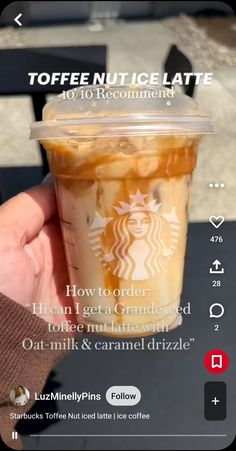 someone holding up a cup of iced coffee