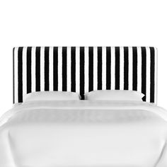 a black and white striped headboard on a bed