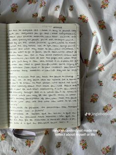 an open notebook sitting on top of a bed