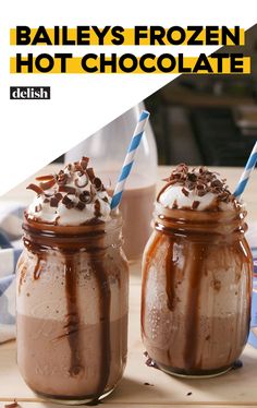 two mason jars filled with chocolate frosting and topped with whipped cream