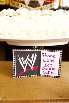 a cake with white frosting and a sign that says stone cold ice cream cake