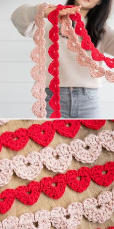 a woman holding up a crocheted scarf with red and pink hearts on it