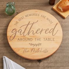 a wooden sign that says, the best memories are made gathered around the table with bread