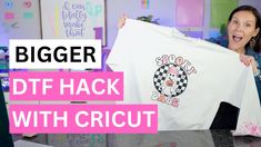 a woman holding up a t - shirt with the words, bigger dtf hack with cricut