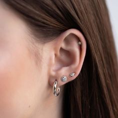 This decorative tiny stud is the perfect add on to your ear stack. Mix and match with our huggies for an on trend look. .925 Sterling Silver Cubic Zirconia Crystal Hypoallergenic post Height 6.2mm x Width 3.1mm Stone center: 2mm #E492 Classic Cubic Zirconia Piercings, Internally Threaded Huggie Earrings, Classic Tiny Sterling Silver Huggie Earrings, Tiny Cubic Zirconia Cartilage Earrings For Everyday, Everyday Cubic Zirconia Cartilage Single Earring, Everyday Internally Threaded White Gold Piercings, Dainty Cubic Zirconia Piercings For Everyday, Dainty Everyday Piercings With Cubic Zirconia, Everyday Nickel-free Cubic Zirconia Jewelry