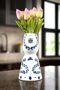 a vase with flowers in it sitting on a table