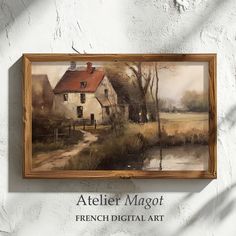 a painting hanging on the side of a wall next to a wooden frame with an image of a house