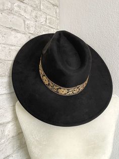 We love this hat, perfect classic black hat with a matching black and neutral brown floral design band! It has a drawstring on the inside if you need to adjust it and make it a little smaller. The fabric material is a soft faux suede that is on the stiffer side! The width of the brim on the hat itself is 3.5" wide. The circumference of the inside of the hat is 22.5” but is adjustable with the drawstring interior and you can make it smaller. Fabric is 100% Polyester. Hand wash only. Fun Black Flat Brim Hat, Artisan Black Hat With Flat Brim, Black Embroidered Curved Brim Hat, Artistic Black Flat Brim Hat, Whimsical Black Brimmed Hat, Bride Headband, Flower Band, Headband Tiara, Jewelry Candles