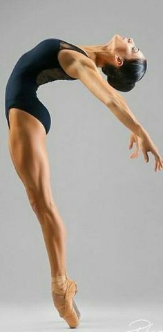 a ballerina in black leotard and ballet shoes is posing for the camera